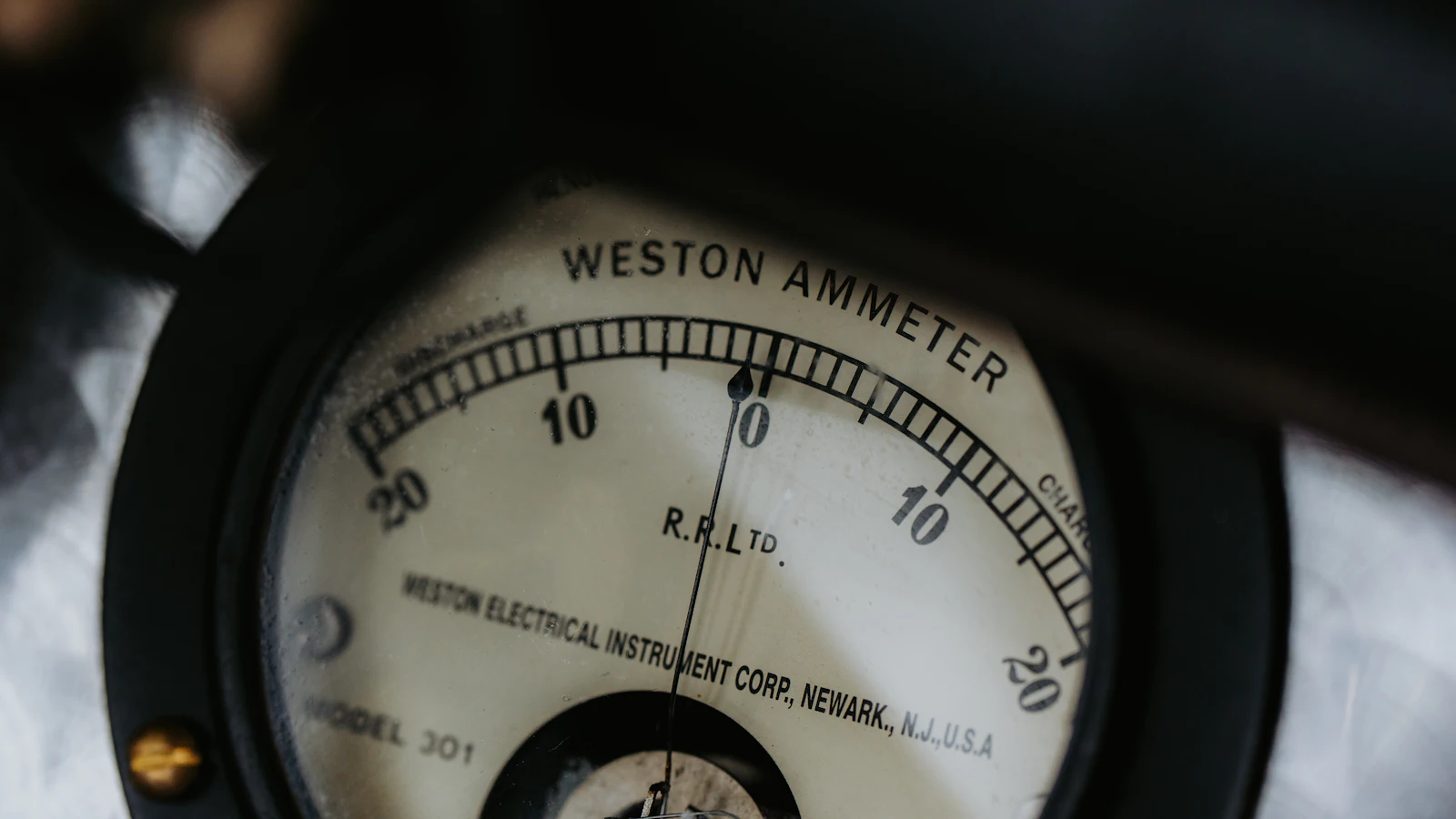 A vintage Weston ammeter with its needle resting exactly on zero, an instrument reporting a reading rather than an opinion — which is what an exit code does for a coding agent