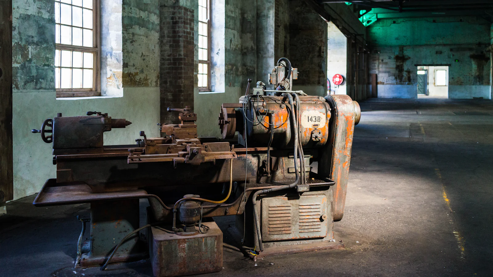 A lathe standing alone in an empty workshop, fully capable and completely idle, which is what a coding agent looks like when specified work runs out